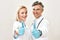 Successful medical team. Portrait of two happy male and female doctors in medical uniform and blue sterile gloves