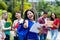 Successful mexican female university student with group of students