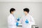 Successful and research working scientists man shake hands together in laboratory