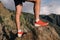 Successful runner hiker enjoy the view on mountain top cliff edge