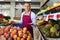 Successful salesman inviting to fruit and vegetable store