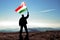 Successful silhouette man winner waving Hungary flag on top of the mountain