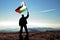 Successful silhouette man winner waving Palestine flag on top of the mountai