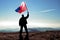 Successful silhouette man winner waving Samoa flag on top of the mountain