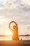 Successful sportsman raising arms on golden sky back lighting sunset summer after cross running. Fitness male athlete with arms up