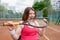 Successful sportswoman bites racket at the tennis court. Healthy lifestyle.