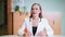 Successful trader businesswoman talking on camera sitting in a bright modern office room. Business woman in white