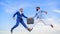 Successful transaction between businessmen.Easy deal business. Businessmen jump fly mid air while hold briefcase. Case