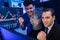 Successful two stock exchange traders raising fist up. Sellable.