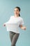 Successful weight loss, woman with too large t-shirt after a diet