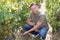 Successful winemaker man working in vineyard