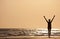 Successful Woman Arms Raised At Sunset on Beach