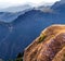 Successful woman standing on the edge of a cliff,reaching her goal