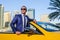 Successful yang businessman in yellow cabrio car.