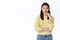 Successful young asian woman in yellow sweater looking determined and confident camera, touching chin thoughtful