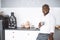 Successful Young Businessman. African American Guy Smiling In Kitchen With A Cup In Hand. Rich Investor In His Home