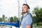 Successful young businessman is enjoying free time at the marina. Yachtsmen portrait with boat