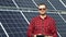 Successful young engineer with tablet planning futuristic solar panels power plant