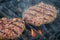 Succulent and appetizing beef hamburgers are roasting on grill grid