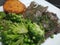 Succulent cooked rump steak with broccoli and peas on a white plate