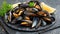 Succulent grilled mediterranean mussels on elegant black plate, a classic seafood delicacy