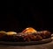 A succulent meat steak ready to be served with a black background.