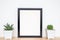 Succulents or cactus in concrete pots over white background on the shelf and mock up frame photo