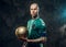 Sucessfull tattooed, bald fashionable male soccer player posing in a studio for the photoshoot with a soccer ball