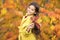 Such colorful season. Little girl welcome autumn season. Kid girl cute face hold leaves. Child with autumn yellow leaves