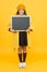 Such a great opportunity. Modern schoolgirl with chalkboard. School girl cute pupil hold blackboard copy space. School