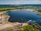 Suction tube dredger in sand mining quarry on sunny day