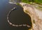 Suction tube dredger in sand mining quarry on sunny day