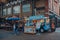 Sud Italia pizza van inside Spitalfields Market, London, UK, woman walking by