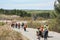 SUDBURY, ONTARIO, CANADA - MAY 21 2009: Group of workers and geologists in hardhats and high-visibility vests walking on