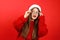 Suddenly surprised woman in red sweater and santa hat. Discounts and New Year wishes