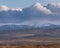 The Sudetes seen from a distance with the peaks partially covered with a layer of dense clouds.