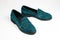 Suede dark green women`s slip-on shoes with a small heel. Close-up shot