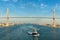 Suez Canal, Egypt, 2017: Ship`s convoy passing through Suez Canal, in the background - the Suez Canal Bridge