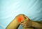 Suffering from joint pain with red spot. Hands on leg as hurt from Arthritis. Osteoarthritis knee disease concept