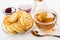Sugar bowl, saucer with pancakes, tea, bowls with jam, spoon