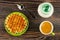 Sugar bowl, wafers in saucer, cup with coffee espresso, spoon on wooden table. Top view