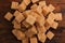 Sugar cane cubes closeup wooden table