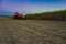 sugar cane field mechanical harvesting with a tractor carrying harvest