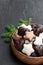 Sugar and chocolate glazed seasonal spiced cookies in wooden bowl on black stone background