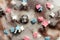 Sugar colored confetti lies on a white icing cupcake, texture of sugar icing on a cupcake surface close-up, pink, blue and white