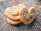 Sugar cookie curls with poppy seed puff pastry on wooden background. Confectionery for the recipe. Pastries, dessert