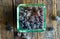 Sugar covered grape in glass box on wooden background