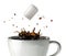 Sugar cube falling and splashing into a cup of black coffee. Close-up view.