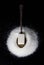 Sugar cube on a spoon. Spoon on a pile of sugar. Photo on a black background. Photo above