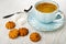 Sugar cubes, spoon, small shortbread cookies, black coffee in cup on saucer on table